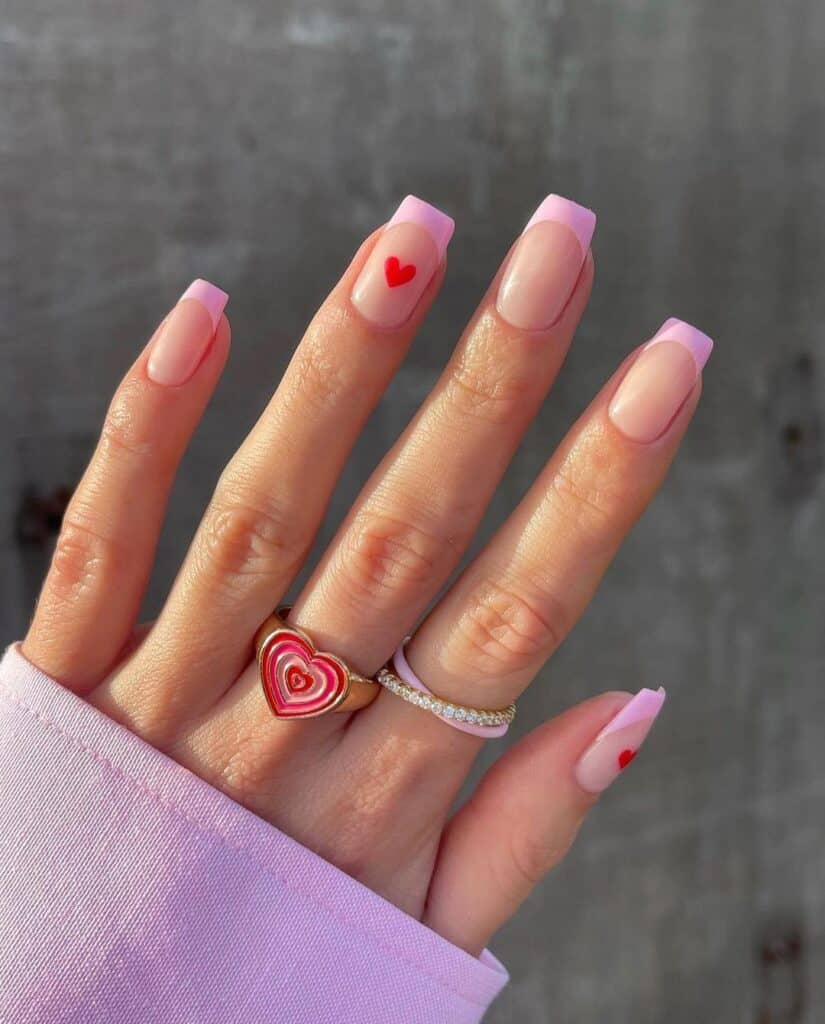 pink French tip nails with red mini hearts