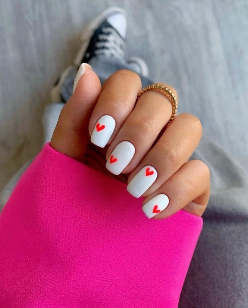 short white nails with mini red hearts