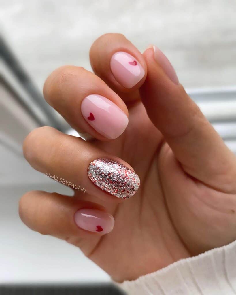 Nude Short Valentine’s Day nails with a Touch of Glittery Effect